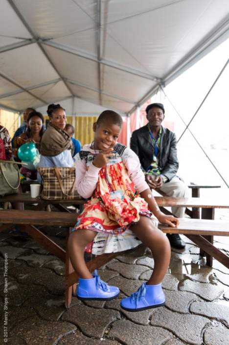 Justine, Orthopedic patient, waiting in the tent during screening.